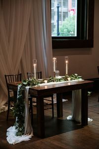 Sweetheart Table with Taper Candles, Greenery, and Draping