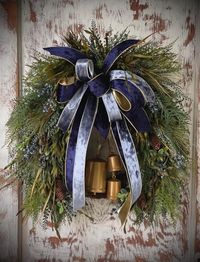 Winter Mix Greenery and Bell Wreath with A Navy and Ice Blue Velvet Bow.  Beaded Grass mixed with Fern, Pine, Cedar Etc.... Added some Pine Cones, Blue Berries and some Beautiful Antique Gold Bells. Fits standard size door or Larger doors. Approx 24-26" wide and 26"-28" in length. Depth is 8"-10".Measurements may vary slightly( 1-2") depending on where you measure. Each One is hand made by me.  This Wreath is the perfect mix of Rustic and Elegance combined.