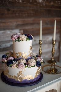 Purple Wedding Cake Gold Leaf Buttercream Roses Vintage Modern Creme de la Creme Cake Company Nine Photography Events by Jade Mopac Event Center- venue Event Paperie- paper products Beautiful Event Rental Vella Nest- Florist