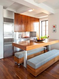 Check out the upholstered benches on wheels that provide seating in this contemporary kitchen on HGTV.