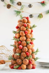 Looking for Christmas desserts for your party?  This donut hole Christmas tree is the perfect centerpiece for your holiday dessert table!  Made with store-bought donut holes and a styrofoam cone, this elegant Christmas treat is sure to wow your party guests!