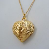 Angel Wings Heart Locket - 14K Gold Plated Sterling Silver - Memorial Love *NEW* This Angel Wing Locket is made of 14k Gold Plated Sterling Silver and is a FashionJunkie4Life original design!  Dimensions: 20mm x 20mm (3/4" x 3/4") Gold plating for this locket is 40 micro inches (1 micron) thick. It is a gem quality plate. Many people have had negative experiences with gold plated jewelry that has a thin wash of gold as little as 1 micro inch thick. Our gold plate is 40 TIMES as thick, at 40 micro inches (1 micron). We find this thickness to be extremely durable. Comes with an 18" 14k gold plated sterling silver cable chain.  Arrives in a gift box. Shipping Details: All orders are shipped within 1 business day (excluding US Holidays) All orders are shipped from Texas, USA International Buye