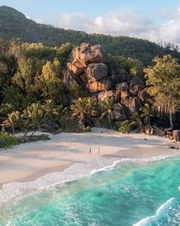 Catching the last sun rays at Grand Anse in Seychelles. In this travel guide to Seychelles with everything you need to know including the best beaches, hikes & activities, which islands to visit, 1-2 week itineraries and where to stay in the Seychelles Islands. #seychelles #seychellesislands