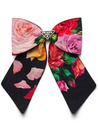 black/multicolour enamel triangle logo all-over floral print oversize bow detail clip fastening