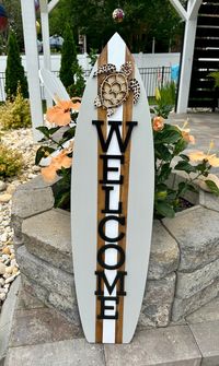 Each Surfboard Welcome Sign  is hand made to order and painted your choice of color. Each sea turtle is individually hand painted for a unique addition. Raised lettering and sea turtle. Heavy duty solid  3/4" wood construction.  Sawtooth hanger is included and installed. We finish each surfboard with clear gloss exterior polyurethane with UV protection.  Sizes Available 23"x7.5" /  35"x9" /  47"x11"