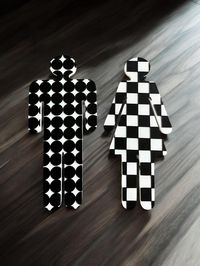 These 3D-printed bathroom sign figures, titled "Objectify Bathroom Female/Male Sign Figures - Spots and Checks," feature a modern design with bold black patterns. The male figure is decorated with a polka dot motif, while the female figure sports a checkered pattern. Both figures have a clean, minimalist aesthetic, making them ideal for contemporary restroom signage or decorative purposes.