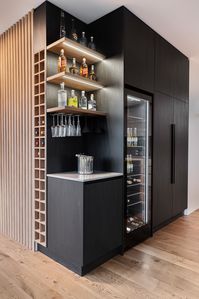 This elegant bar design has a space for everything, led lighting and sits perfectly next to the integrated fridges. Timber battens complete the design.