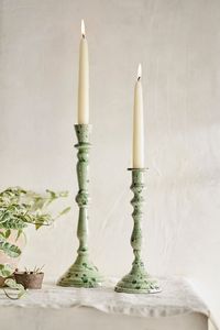 Complete your tablescape with the soft glow of a taper candle, held in this enameled candlestick.