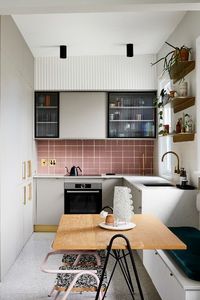 While this apartment might be small in size, it's big on colour & character. Matte pink wall tiles, terrazzo floor tiles, Laminex Brushed Brass and Laminex Baye come together to create this playful apartment designed by Strutt Studios. Design: Strutt Studios. Photography: Caitlin Mills for The Design Files. Styling: Annie Portelli.