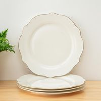 Distinctive Design: Set of 4 dessert plates with an elegant scalloped edge and gold rim. Everyday Durability: Perfect for daily meals, crafted for lasting use. Ideal Size: 8 inches, perfect for desserts and appetizers. Sophisticated Touch: Adds elegance to any table setting. Hassle-Free Cleaning: Dishwasher safe for easy care. Elevate your dining experience with our set of 4 porcelain dessert plates, featuring a unique scalloped edge and a chic gold rim. These 8-inch plates are perfect for serving desserts and appetizers, adding a touch of elegance to your table.