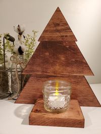 This adorable little wooden tree is perfect for sitting on a counter, mantel or coffee table.  It's handmade in my shop by me using 1 x 4 pine, stained in a red oak stain and glued together with wood glue.  The base is sturdy enough to sit on most every surface.  It is displayed with a 1/2-pint jelly jar and a battery-operated tea light for safety.  Perfect for any home.  I loved making these.  This would make a great housewarming gift or any type of gift for that special person. *TEA LIGHT AND