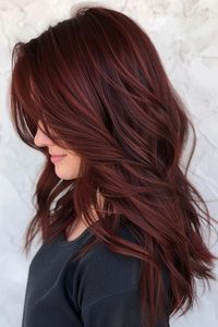 Goodbye, boring hair - hello, showstopping red! Check out our blog post that is sharing over 30 of the prettiest red hair colors that are just wow. You'll see subtle shades like the dark red brown hair color here and dramatic tones like ruby, redwood, and more. Click through to the blog and save this pin so you can view all the stunning shades later!