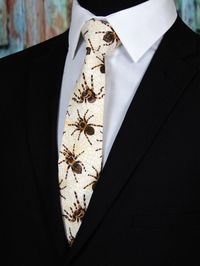 "Have fun with this men's creepy crawly spider necktie. Features a cream background with orange, black and brown spiders. Available as a skinny tie and a extra long tie. Pocket Square available upon request pending available of fabric. Cost is $10.99 Message me to check availability. Expertly hand-made from 100% cotton you can select your length from 57\" to 71\" (Great for taller Men). Width is standard 3.5\" as shown here or skinny 2.5\". If you require a custom length or width, please contact