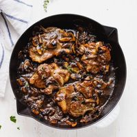 Oven baked pork steak in a cast iron skillet