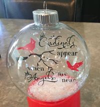 Floating ornament. Cardinals appear. I cut out the design on vinyl using my Cricut and attached it to an acetate ornament I cut out, then inserted it into the round glass ornament, lastly I added some fake snow. Check out my website (blog) for info on how to make Floating Ornaments.