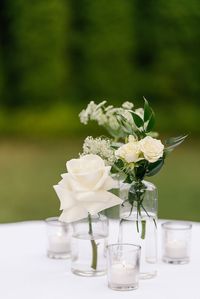 White and green florals in clear glass for a simple and beautiful cocktail centerpiece. Photo by Holcomb and Co.