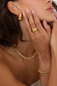 tarnish and water resistant jewelry for everyday. Gold Crossover statement ring. Gold Dome Drop Earrings.