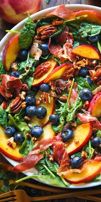 SUMMER - Peach Blueberry Spinach Salad with Pecans, Prosciutto, and Balsamic Glaze. is a light and fresh recipe that combines sweet and savory flavors. Featuring prosciutto, pecans, and balsamic dressing, this 30-minute salad is a perfect side dish or appetizer to make for a crowd or share with your family. Bring it to Summer picnics, potlucks, and other summer festivities. Use fresh peaches in the summer and canned or frozen ones year-round. You can even grill your peaches if you like!