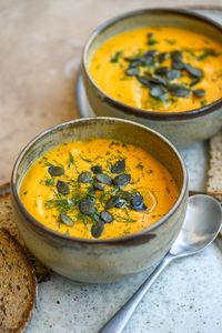 This roasted butternut squash soup is super creamy, easy to make and delicious! It combines roasted butternut, carrots, and garlic with thick coconut milk (making it completely dairy-free.) This is the perfect cozy and comforting meal. #VeganRecipes #SoupSeason #SoupRecipes #EasySoupRecipes #GlutenFree #Plantbased #DairyFree #WeeknightDinnerIdeas 🧡🌿🥣