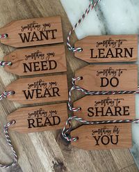 "We love starting traditions with our little ones (especially when it involves wood). These tags are the perfect way to hilight their holiday gifts. Made from cherry wood, and laser engraved. Option 1: Something you want Something you need Something to wear Something you read Option 2: Something to learn Something to do Something to share Something for you Option 3: All 8 tags 3.5\"x1.5\""