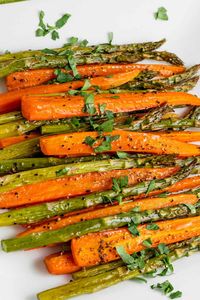 Roasting carrots and asparagus together in the oven is quick and delicious! This recipe is an easy side dish that pairs with array of dishes. Serve the vegetables with lemon wedges and grated parmesan.