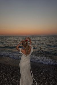 Beach Sunset, Seaside Romance, Ocean View, Summer Evening, Flowing Dress, Sunset Photography, Coastal Beauty, Relaxing by the Sea, Beach Vibes, Golden Hour, Dreamy Landscape, Vacation Mode, Serene Ocean, Bohemian Style, Tranquil Moment