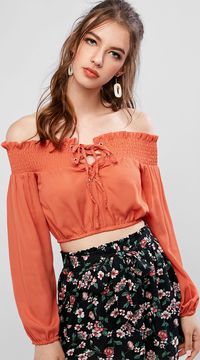 Cut in a cropped length to show off the waist, this bright blouse, styled with an enchanting off-the-shoulder collar accented with smocked frilled trims and front lace-up details, is definitely a great piece to go with high waisted bottoms for various styles. Long sleeves drape naturally with handy elastic cuffs.