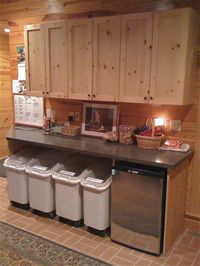 Sweet idea for kennel. Storage with a small fridge for dog foods. Love the wood choice for overhead cabinets.