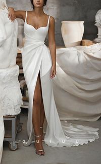 Look stunning on your special day in this chic and modern mermaid wedding dress featuring graceful straps, a V-Neck bodice, draped boho details, and a stylish sweep train. The perfect gown for a modern yet timeless look.