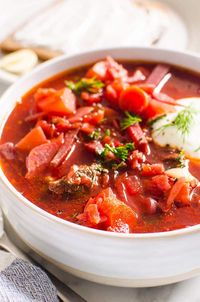 Ukrainian Borscht is a simple sweet and sour soup made with beets, cabbage and dill. This easy soup recipe will be one of the most healthy and delicious vegetarian soups you have ever tried!