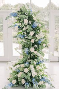 The Camille Floral Pillars were designed with a timeless French vineyard style, using ivory garden roses, white playa blanca roses, white delphinium, dusty blue delphinium, ivory veronica, white ranunculus, white anemone, ivory rose buds, with seeded eucalyptus, and sage spiral eucalyptus. They are absolutely breathtak