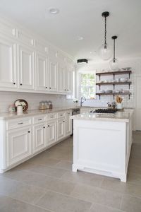 White kitchen cabinets with subway tiles for backsplash and travertine - Home Decorating Trends - Homedit