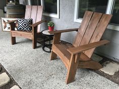 two wooden chairs sitting on top of a patio