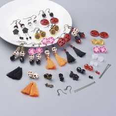 a white plate topped with lots of different types of buttons and earrings on top of a table