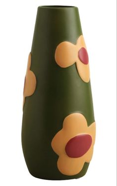 a green vase with yellow and red dots on it