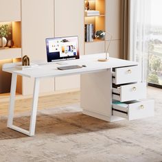 a white desk with drawers and a laptop on it