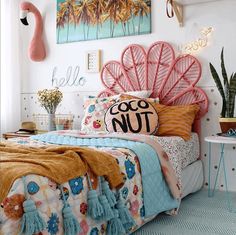 a bedroom decorated in pink, blue and yellow with flamingos on the headboard