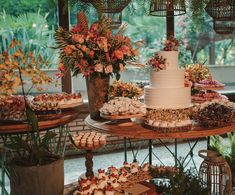 a table topped with lots of cakes and cupcakes