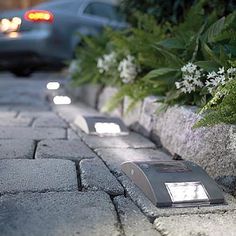 there are two lights that are on the sidewalk