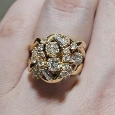 One 14kt Yellow Gold 1.88 Cttw. Round & Baguette Cut Diamond Dome Style Cluster Ring Seventeen Round Brilliant Cut Diamonds: Meas: 4.15 To 2.11 Mm Total Carat Wt. 1.63 Cttw Clarity: Vs-2 To I-1 Color: G-H Cut: Good Also Set: Two Baguette Cut Diamonds (Vs1-2, G-H) Weighing 0.25 Cttw. Note: Stone Weights Calculated By Formula Total Weight Of Item: 9.8 Grams Retail Replacement Value: $5,600.00 Dome Cluster Measures About 15mm X 17mm In Width And Length. It Sits About 12 Mm Tall Off The Ring. Preown Luxury 14k Gold Cluster Ring, Luxury Vintage Cluster Ring Collectible, Luxury Yellow Gold Cluster Ring Collectible, Luxury Multi-stone Cluster Ring In 14k Gold, Antique Multi-stone Yellow Gold Cluster Ring, Baguette Cut, Baguette Cut Diamond, Ring Pictures, Cluster Ring