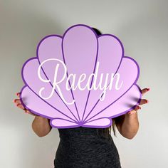 a woman holding up a sign with the word raedyn on it