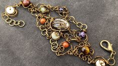 an ornate gold bracelet with multi colored beads