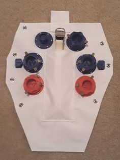 a piece of white paper with red and blue buttons on it