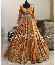 Made to Order/Measurement/Custom Order Lehenga - Color : orange brown - Fabric : Pure Silk - Fully flared paneled lehenga -   Pure Banarasi  Silk -   Attached  Dupatta with Blouse - Drawstring closure with Tassels - - It can be customize in any design or size  PLEASE NOTE: BUYERS ARE RESPONSIBLE FOR ANY CUSTOMS AND IMPORT TAXES THAT MAY APPLY. This is a made to order product. If you opt for 'Made To Measurement Option', we will provide a measurement template and you can share the measurements li Designer Orange Sharara With Gota Work, Designer Orange Sharara With Traditional Drape, Festive Brown Salwar Kameez With Dupatta, Brown Anarkali Set With Dupatta For Festive Occasions, Designer Wear Orange Floor-length Sharara, Festive Brown Anarkali Set With Dupatta, Designer Floor-length Orange Sharara, Orange Floor-length Sharara, Designer Orange Anarkali Set With Pallu Detail