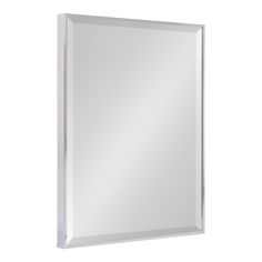 a white framed mirror on a wall