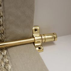 a close up of a gold door handle on a curtain