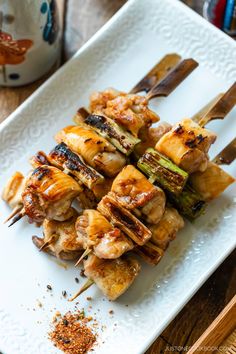 grilled chicken and vegetable skewers on a white plate