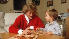 a woman sitting at a table with a boy in front of her and the words bazzar on it