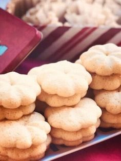 several cookies stacked on top of each other in front of a red and white box