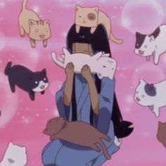 a person holding cats and dogs in front of a group of other cats on a pink background